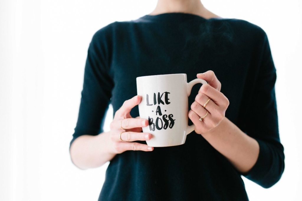 woman holding coffee mug that says like a boss