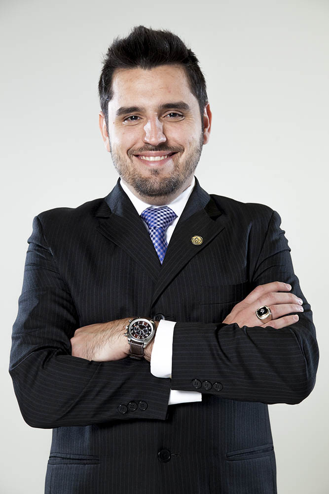 business man smiling with arms crossed in suit and tie