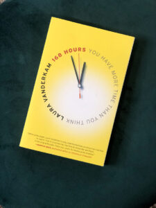 A yellow book with a clock on it sitting on a green chair showcasing business resources.
