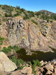 view of pond from top of a mountain