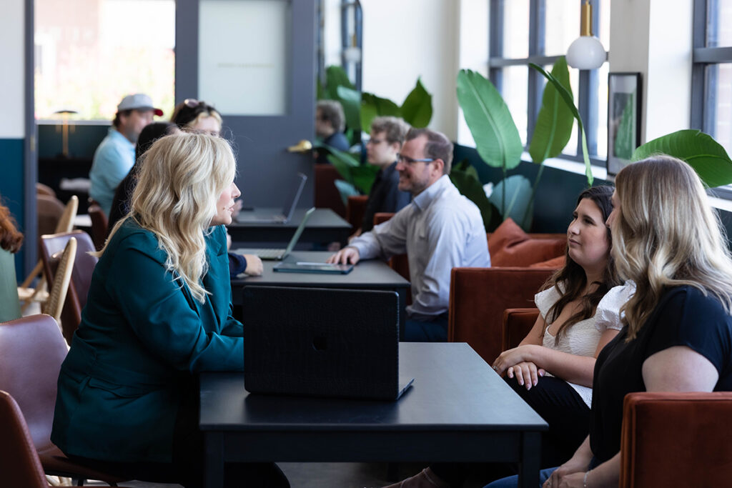 Marketing strategist meeting with clients to clarify brand foundations, small business branding, and brand strategy for entrepreneurs.