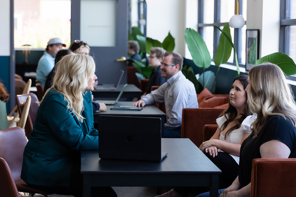 Marketing strategist meeting with clients to clarify brand foundations, small business branding, and brand strategy for entrepreneurs.