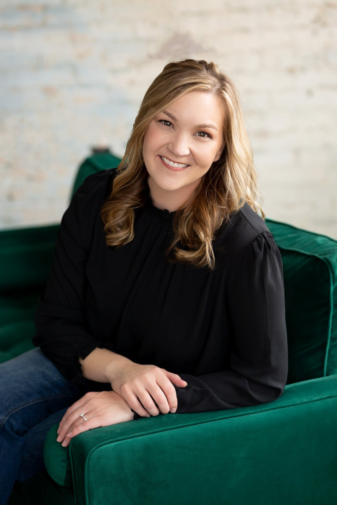 A woman sitting on a green couch during a branding mini shoot.