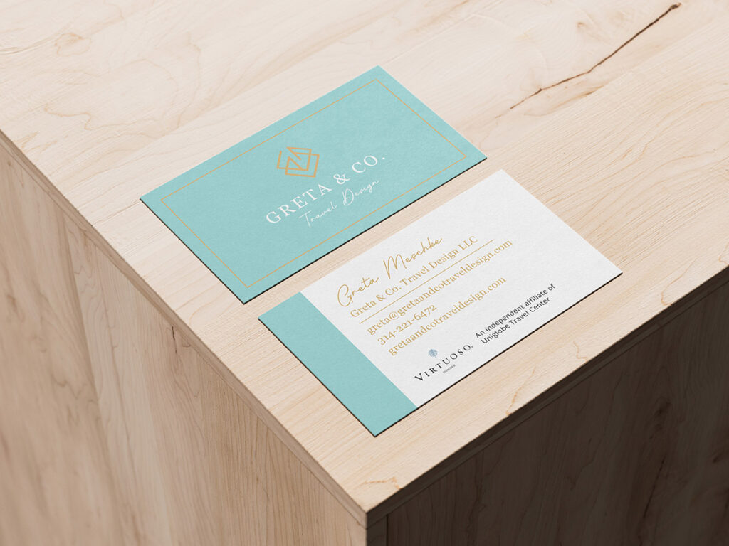 A graphic design portfolio business card sitting on top of a wooden table.