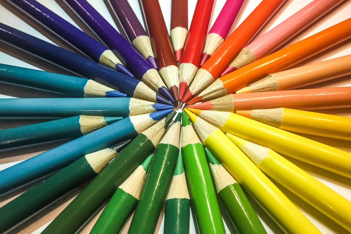 Colorful pencils arranged in a circle on a white surface, showcasing a brand you love.