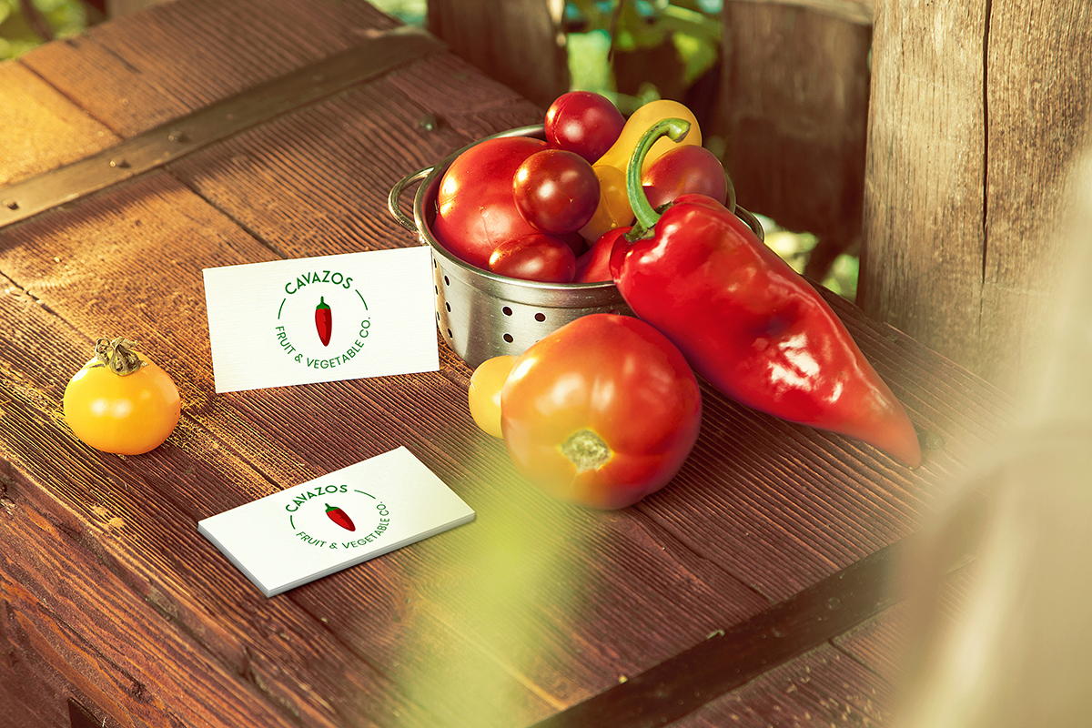 Red peppers and tomatoes on a wooden table.