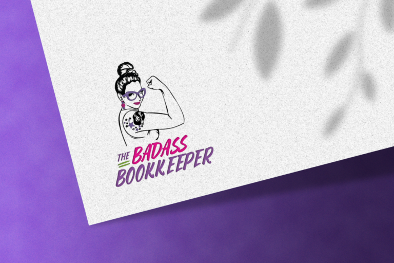 A graphic illustration of a woman with a bun and glasses, flexing her arm, embodies the brand identity of "the badass bookkeeper," displayed on a white surface with a purple corner and accented