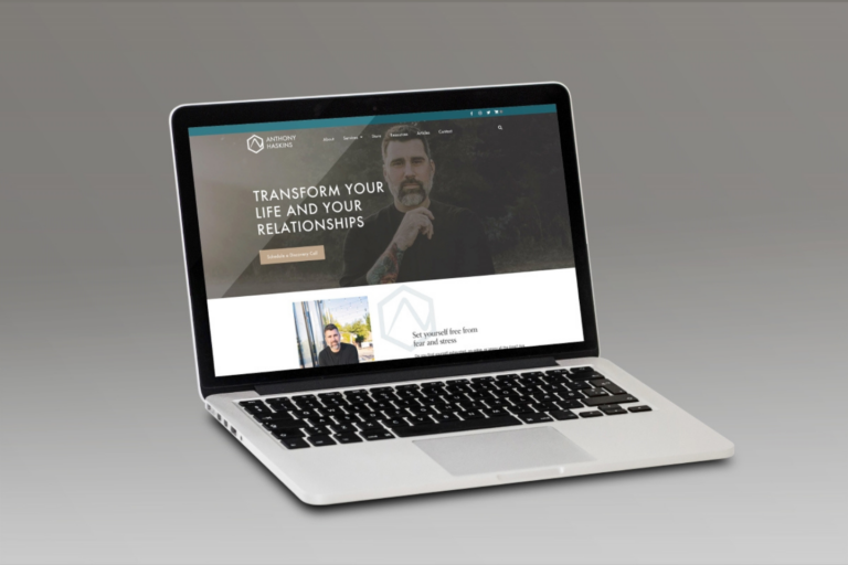 Laptop displaying a self-improvement website with a focus on life and relationship transformation, designed around a unique brand identity.