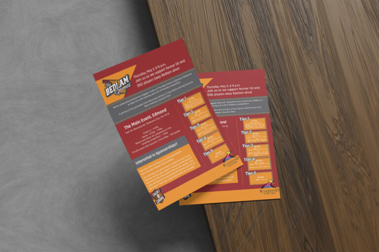 Two colorful promotional flyers for a product called "belta" placed on a wooden table next to a textured gray surface.