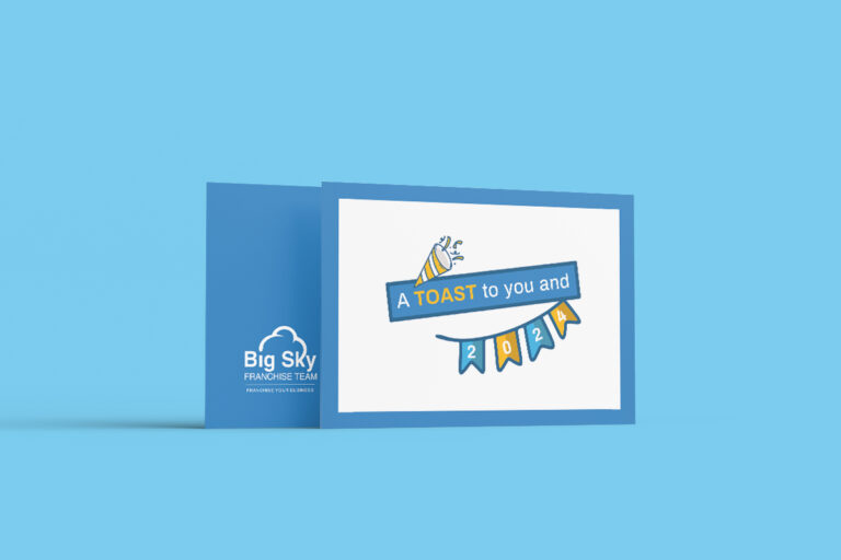 Greeting card from big sky franchise team featuring a playful design with a toast graphic and the text "a toast to you and 2022!" on a light blue background.
