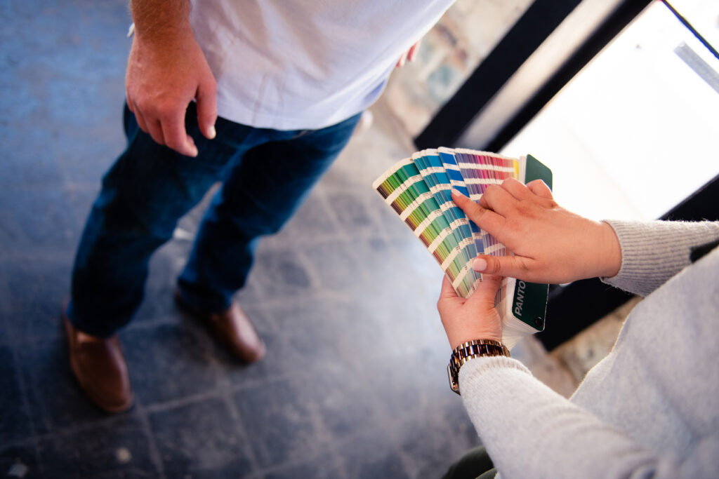 business owner pointing at color samples with customer