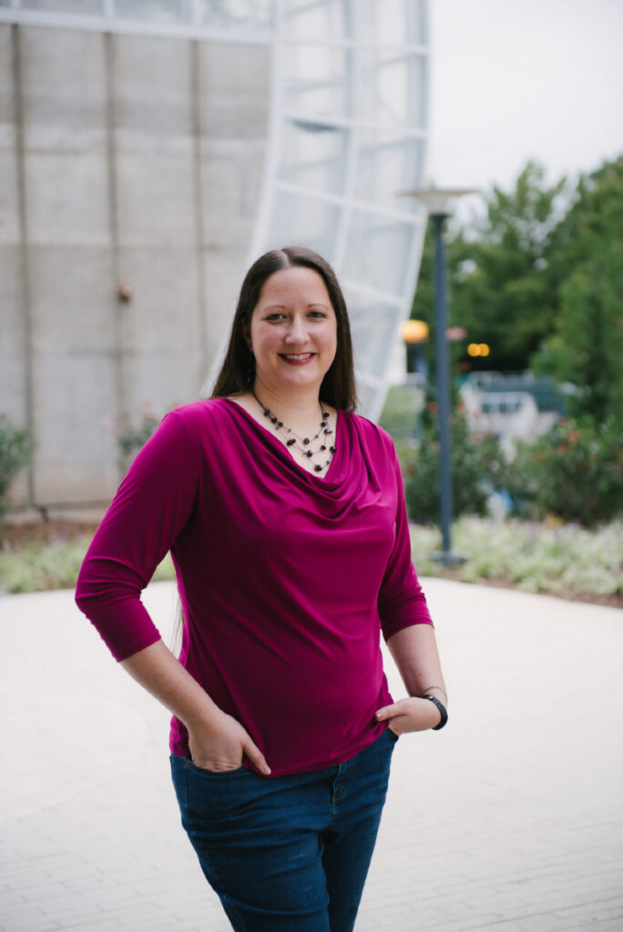 Linda Wesley, freelance partner and Word Nerd, smiles outdoors while collaborating with a creative agency team.