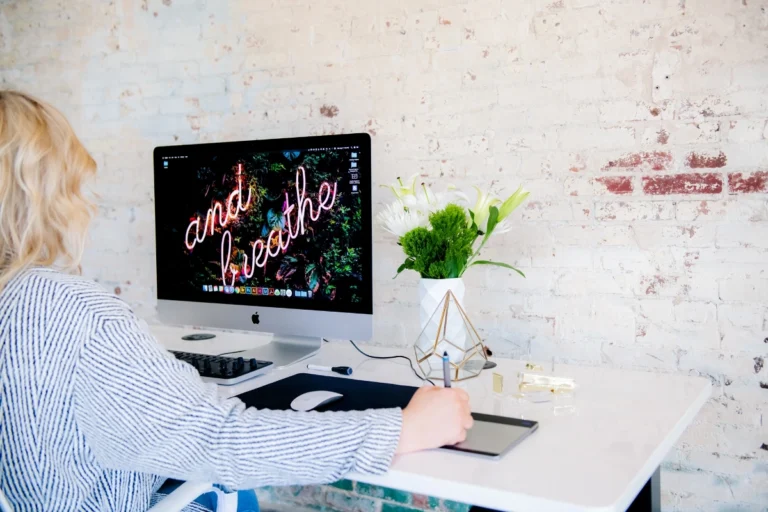 Crystal Oakes at her computer with “Just Breathe” on the screen, reflecting Small Business Marketing Tips x4 for staying calm and focused in Q4.