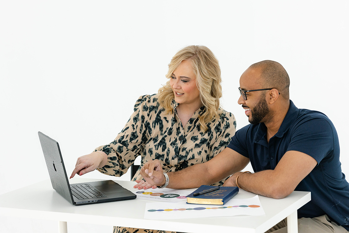 Business owner and marketing strategist reviewing data together during a small business marketing audit to inform a strategic marketing plan.