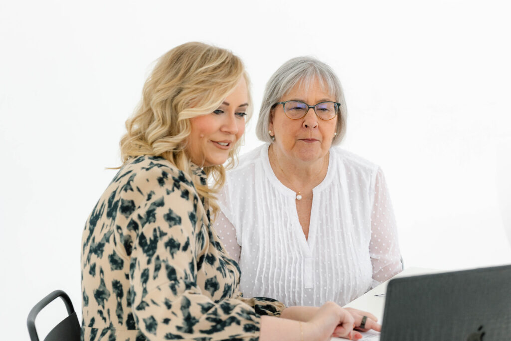 Marketing strategist reviewing website performance with a client to improve website conversion through small business website optimization guided by a marketing roadmap.