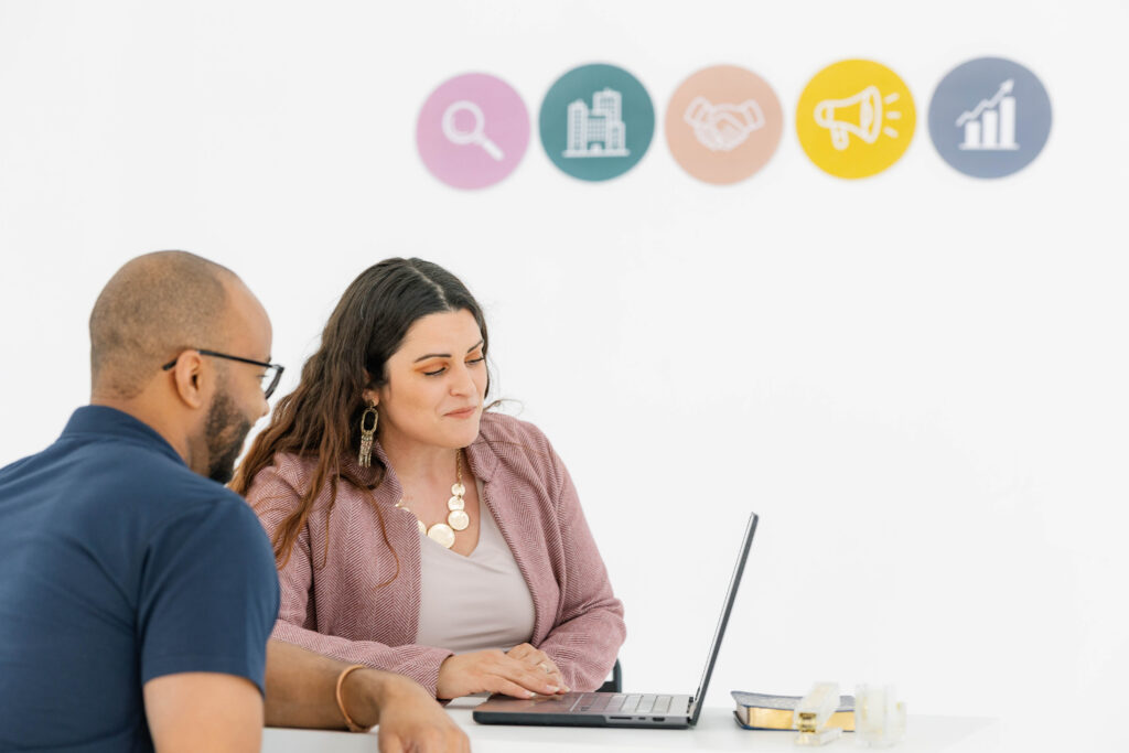 Marketing consultant guiding clients through a paid ads strategy discussion supported by a marketing roadmap for smart small business advertising growth.