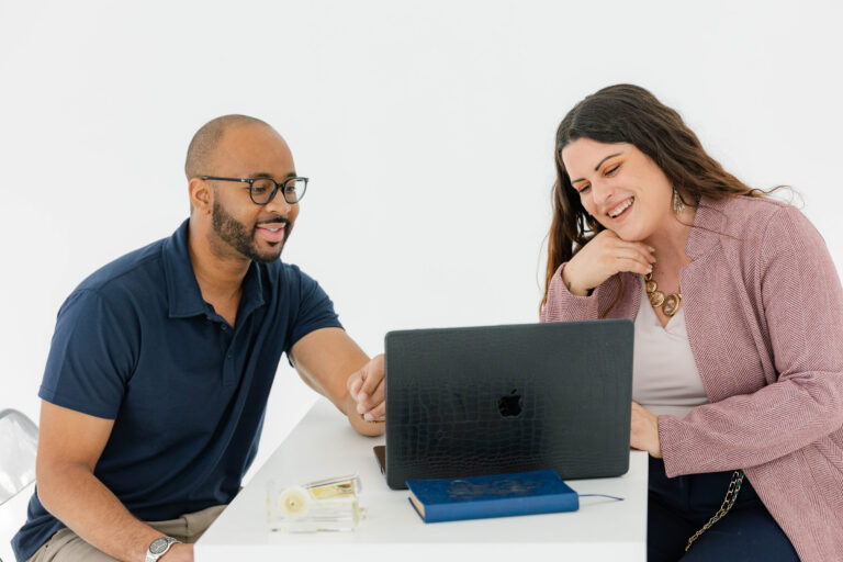 Business consultants reviewing website content to fix messaging mistakes and improve brand messaging clarity through a strategic marketing roadmap.