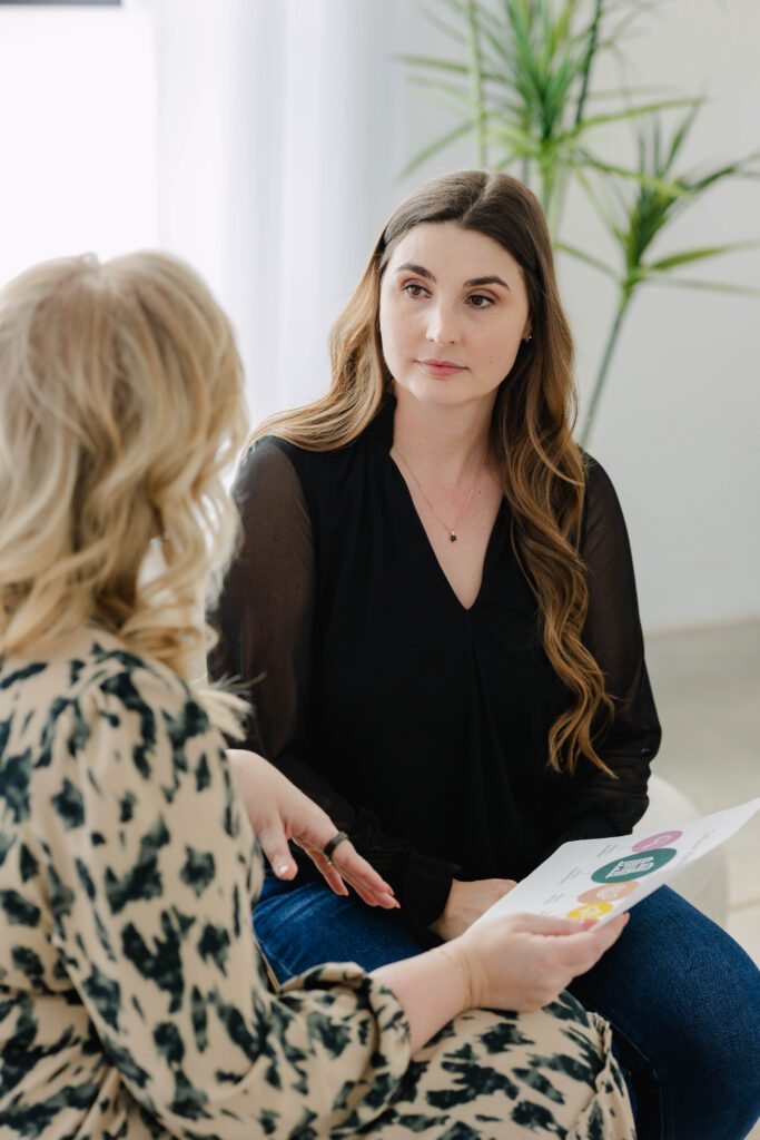 Marketing consultant reviewing strategy document with client to identify messaging mistakes, improve brand messaging clarity, and refine a marketing roadmap.