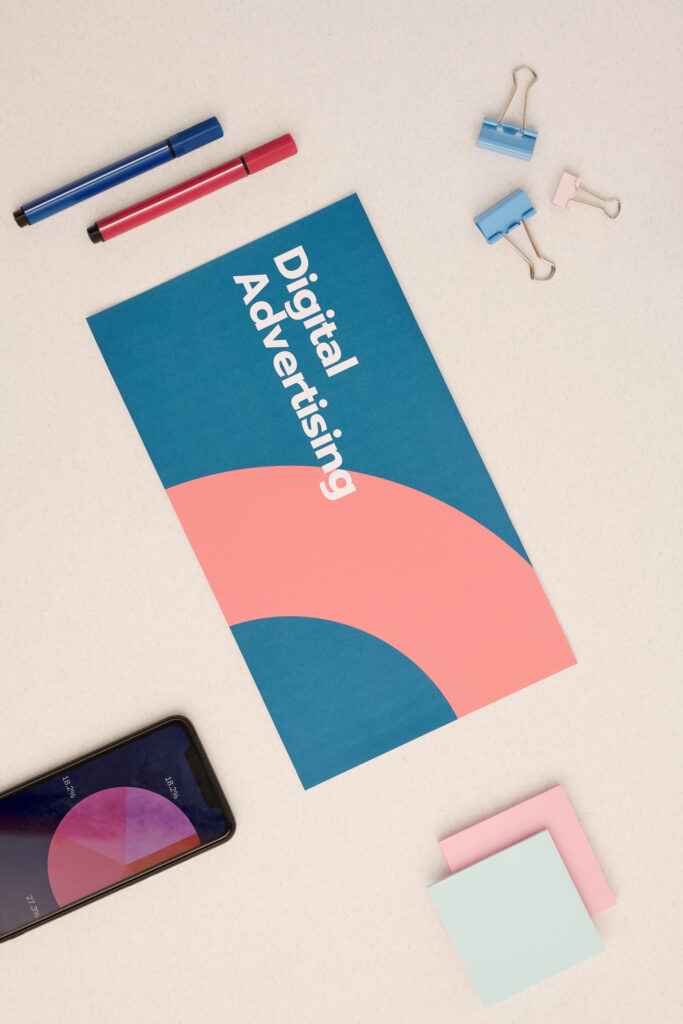 Digital advertising brochure and analytics tools representing a paid ads strategy guided by a marketing roadmap for strategic small business advertising.