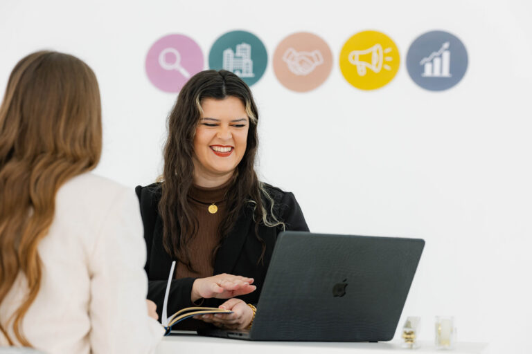 Marketing strategist meeting with a business owner to create a marketing roadmap that supports sustainable business growth without burnout.