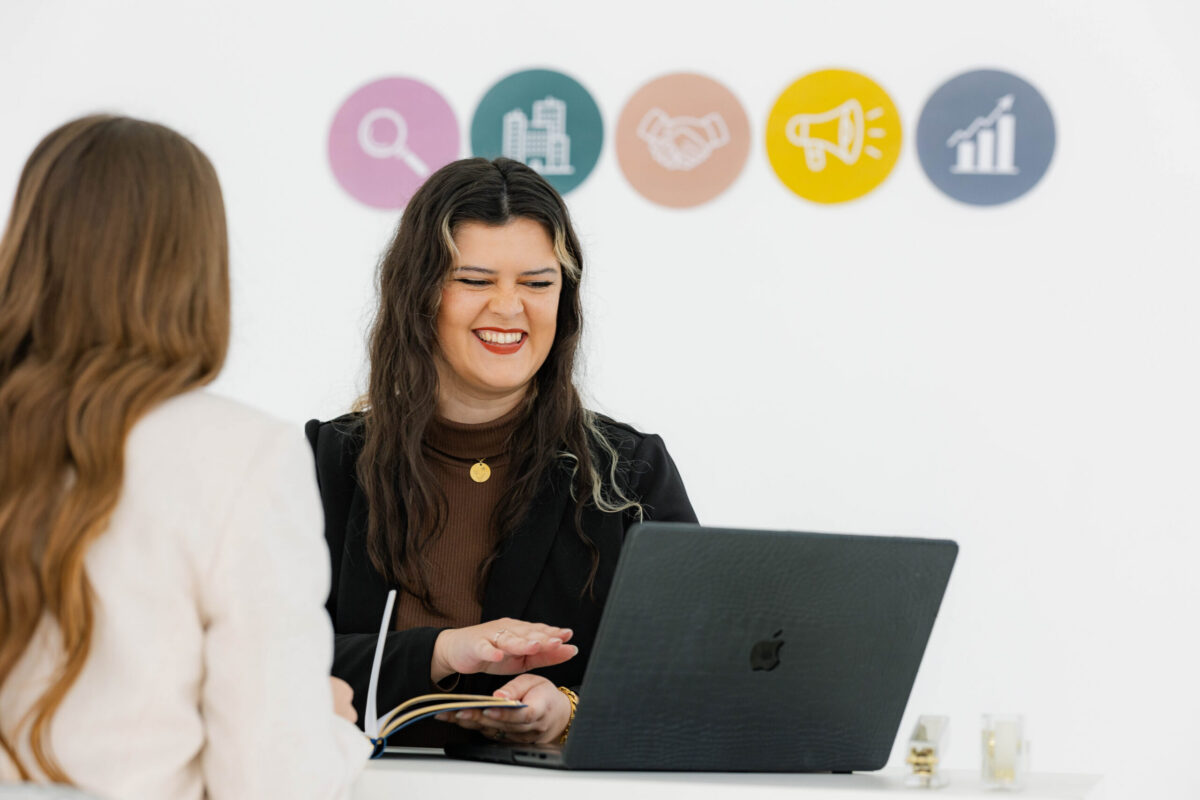Marketing strategist meeting with a business owner to create a marketing roadmap that supports sustainable business growth without burnout.